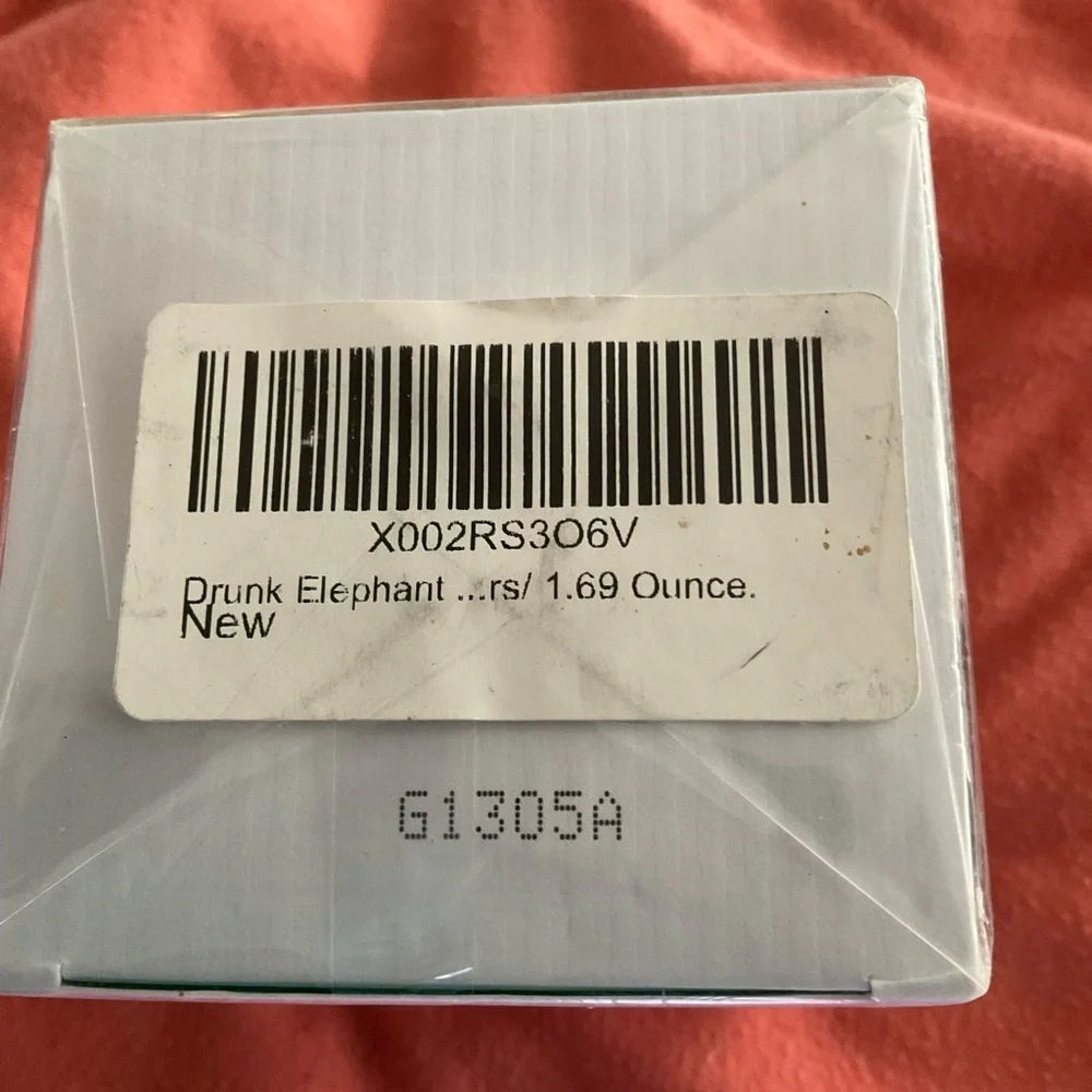 Drunk Elephant Facial Moisturizer with Green Text